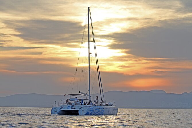 Catamaran sailing at sunset with tapas Palma de Mallorca - Cala Vella nature reserve cove stop: swimming time and paddle surf options
