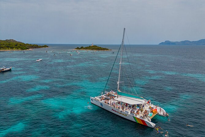 Mallorca Catamaran Cruise with Scenic Views and BBQ Lunch - Aucanada Beach and the lighthouse photo stop