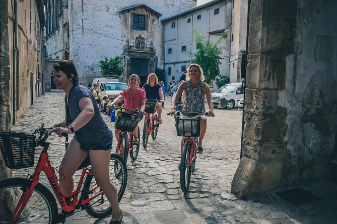 Palma de Mallorca Bike Tour with tapas - Stop at the old harbor approach, plus churches you will actually remember
